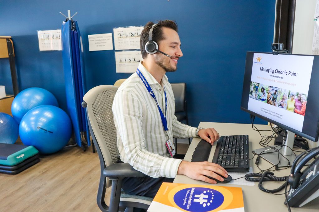 Physiotherapist leading a virtual Managing Chronic Pain Workshop in the Physio Room at Central.