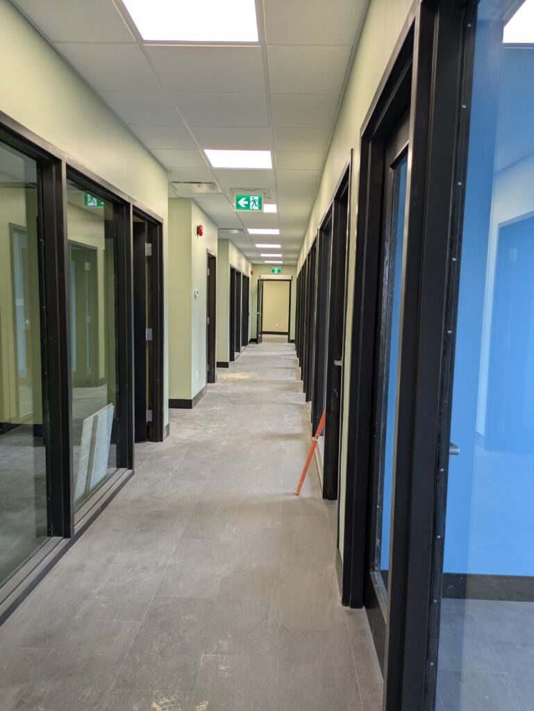 A hallway with glass doors on either side.
