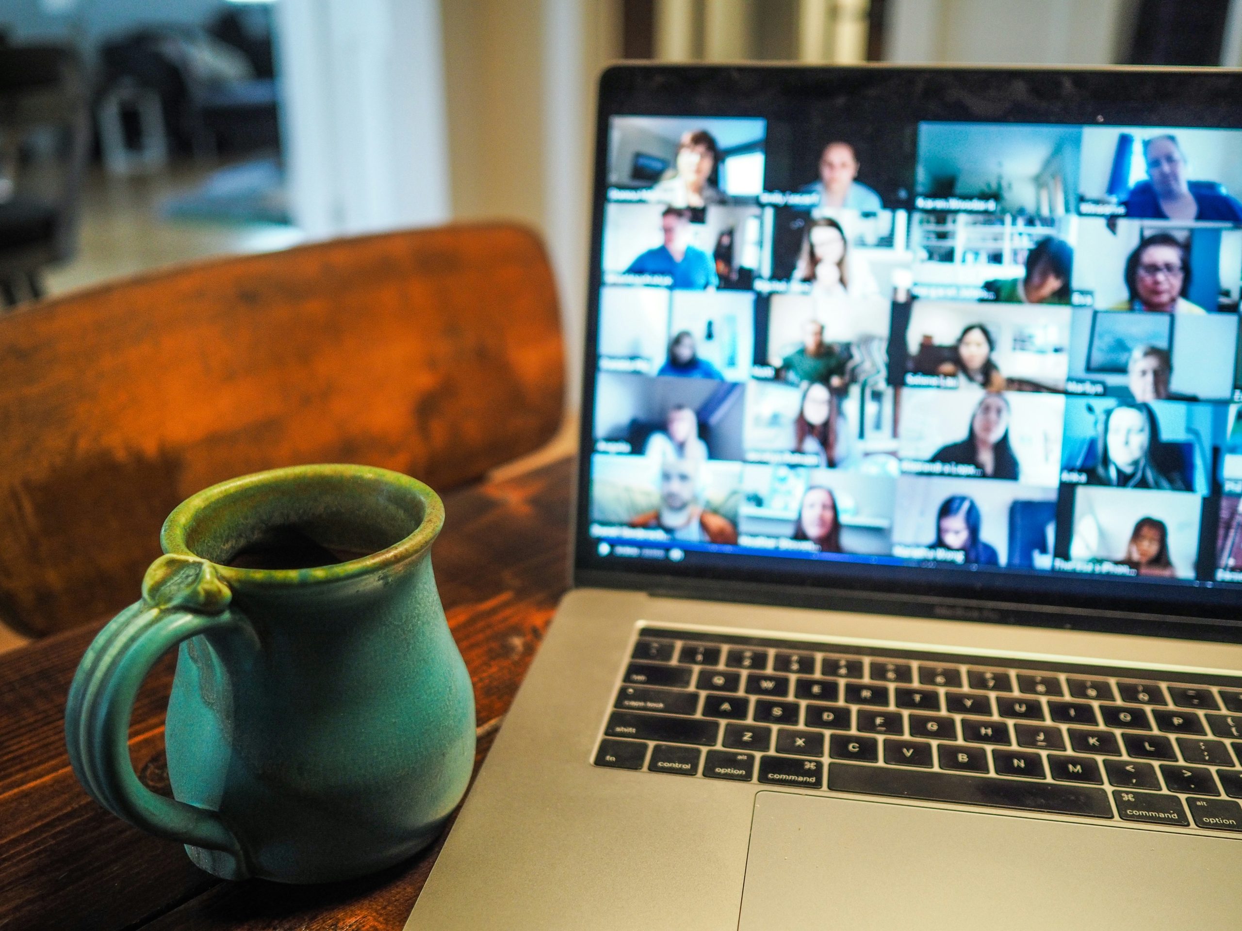 A coffee cup next to a Macbook displaying free health groups and workshops in Hamilton